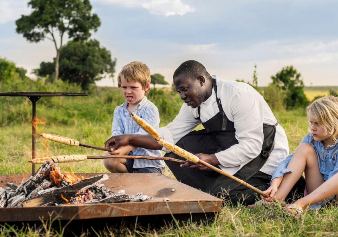 Kids cooking bread on a stick on safari