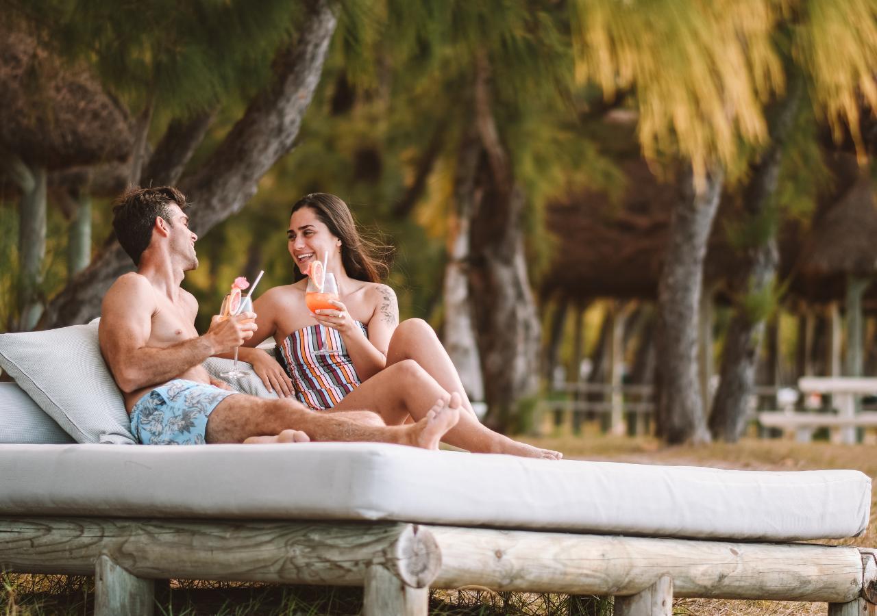 couple enjoying drinks on a private island beach in Mauritius