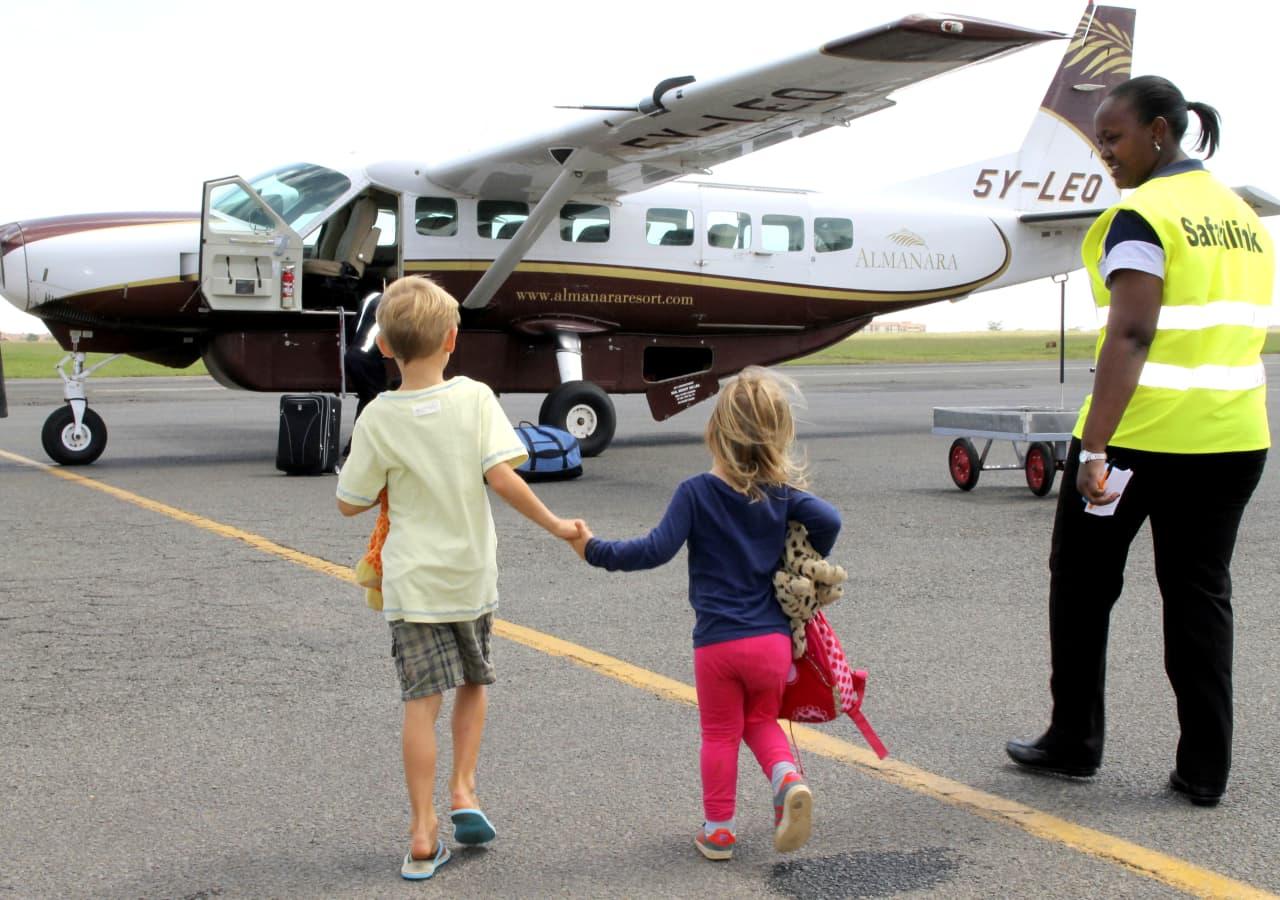 kids walking towards a light aircraft