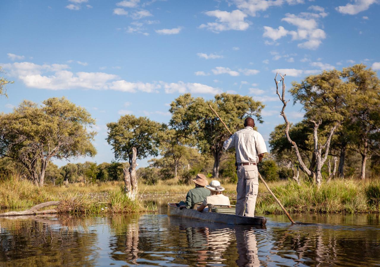 two people on mokoro safari with a guide in Botswana
