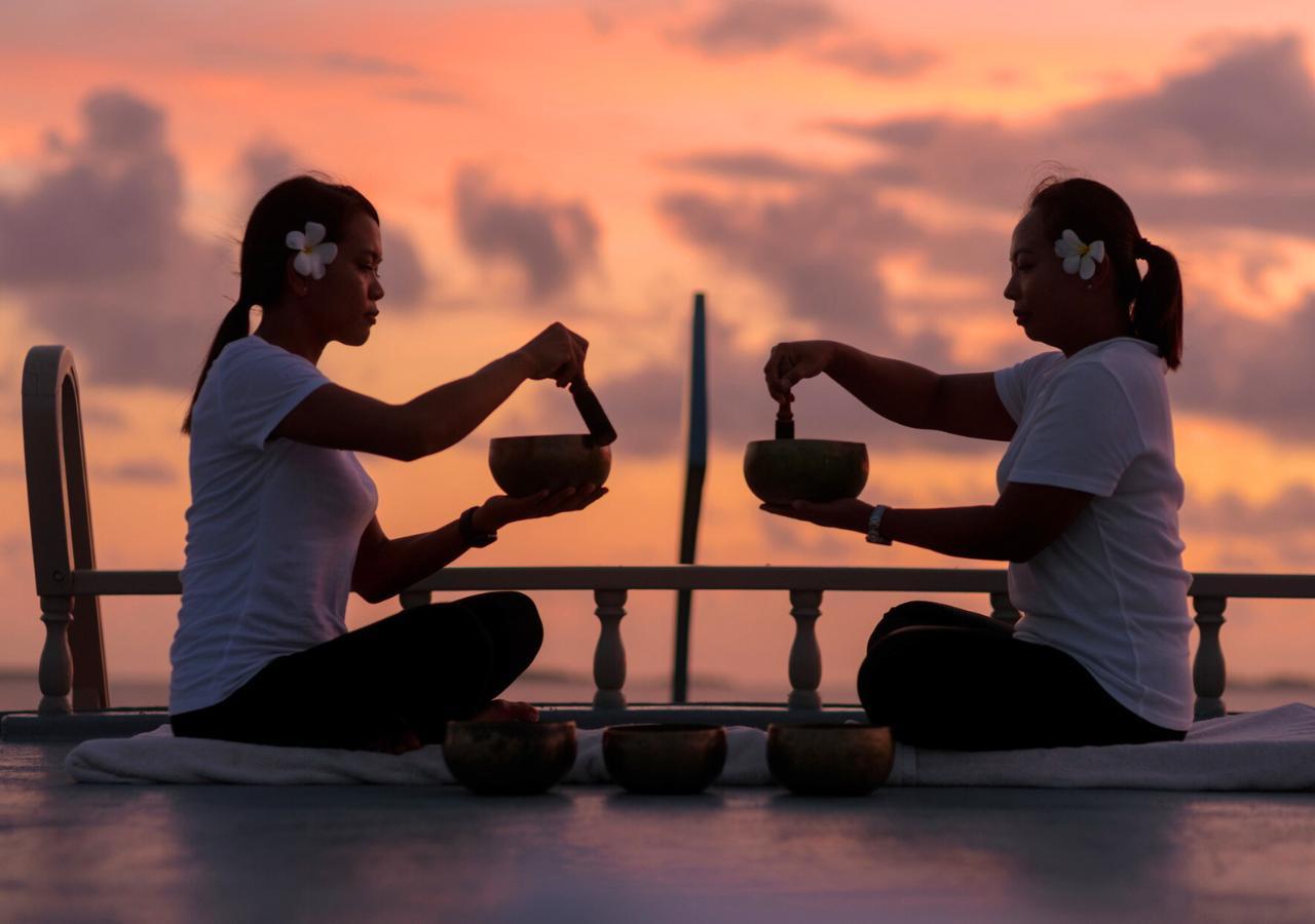 two women performing a sound healing experience at LUX South Ari Atoll