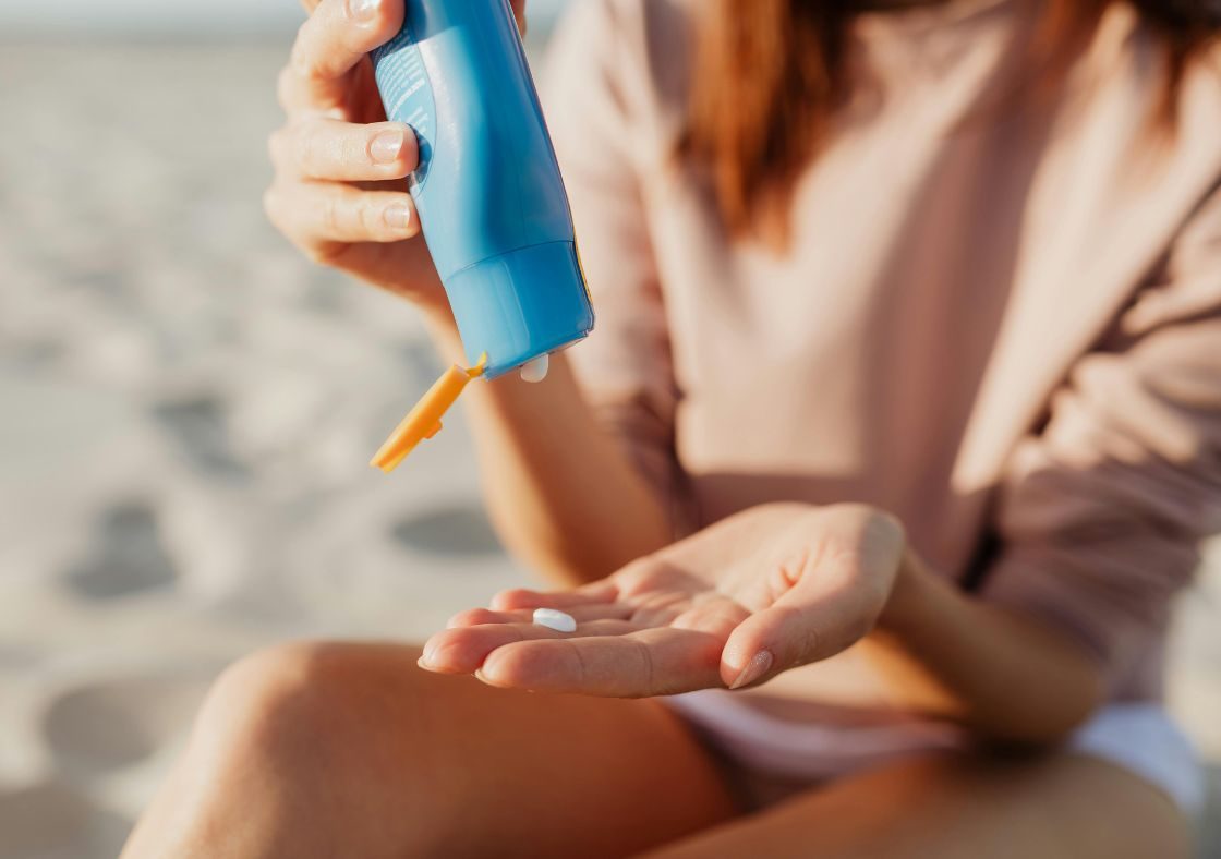 Woman applying sunscreen