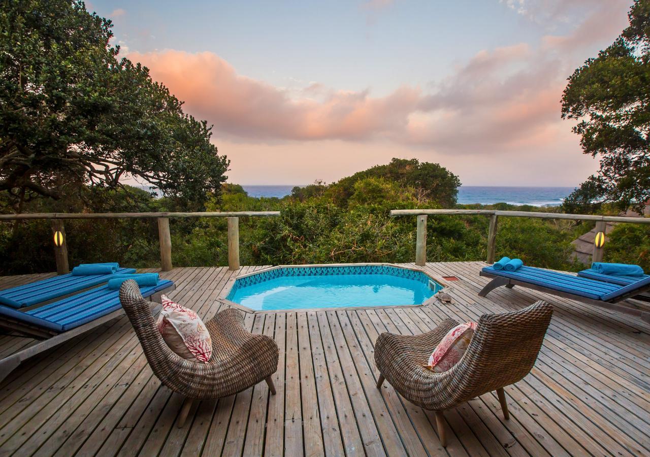 deck with a pool and ocean view at Thonga Bay Lodge