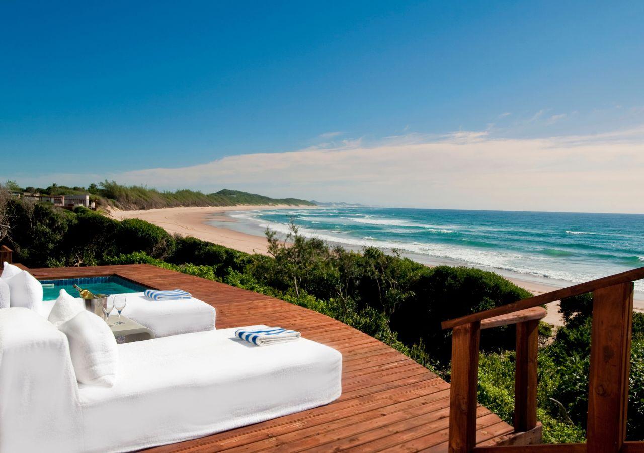 Plunge pool with a deck overlooking the ocean