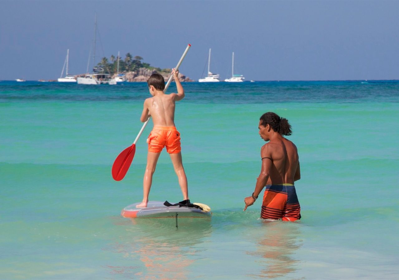 Paradise Sun kid paddleboarding