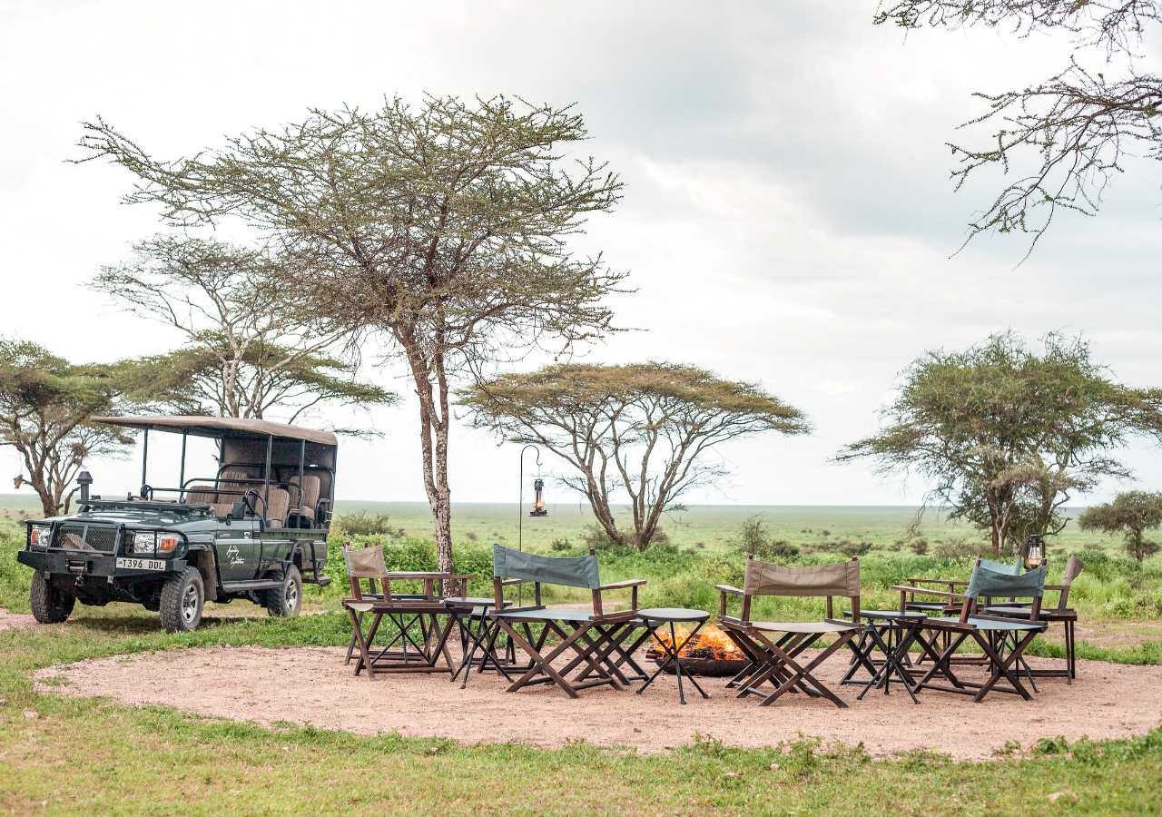 Nyasi Tented Camp Campfire and safari vehicle