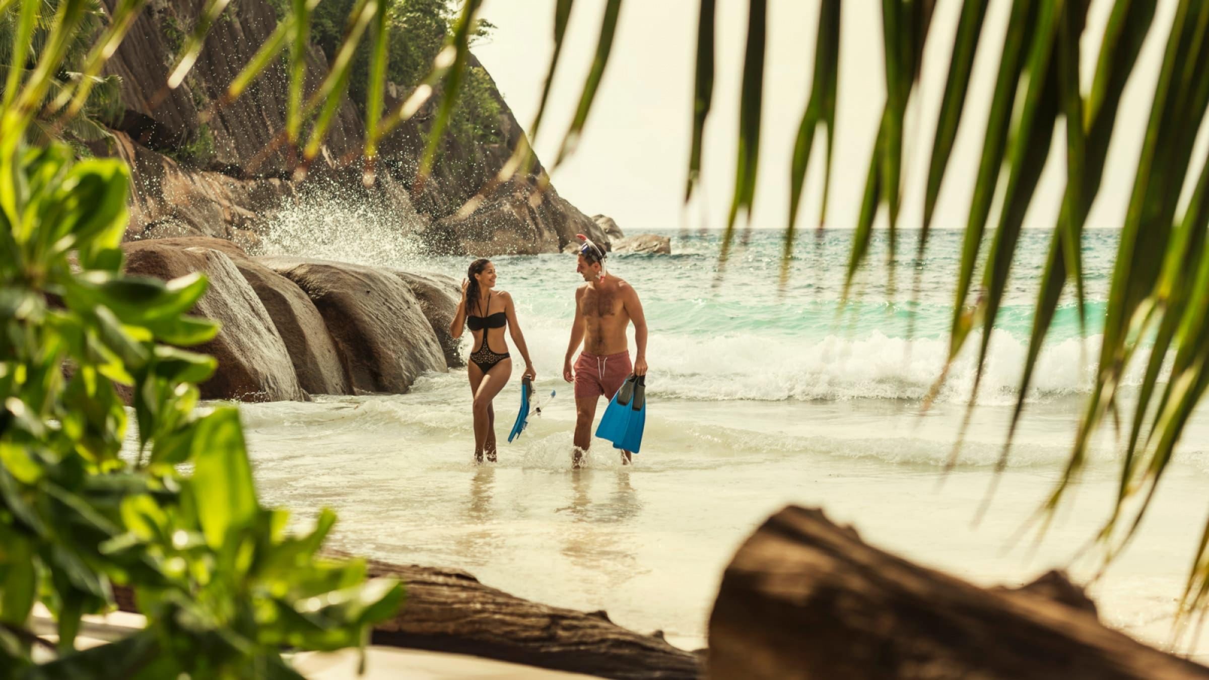 Seychelles four seasons beach snorkel couple