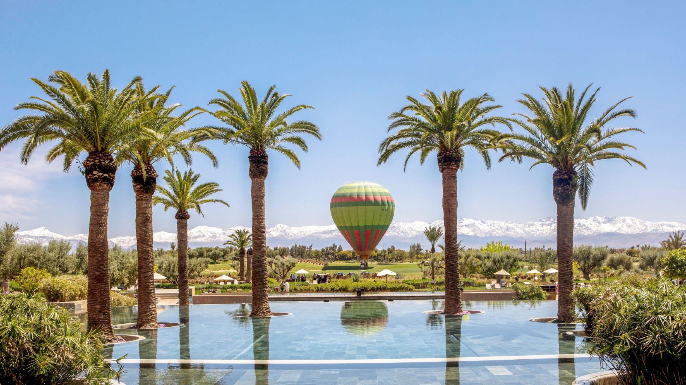 Fairmont Royal Palm Marrakech - hero image of swimming pool with hot air balloon in background