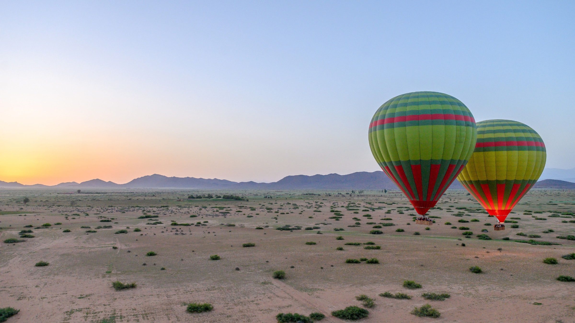 Hot-air balloons over Morocco Desert at sunrise
