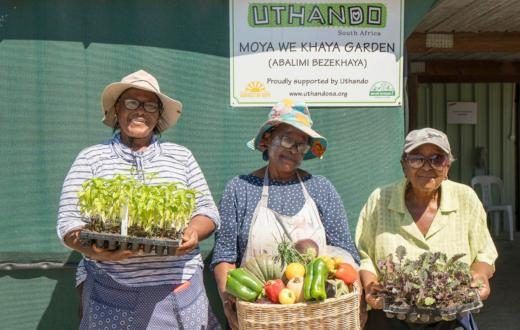 Uthando women holding veg
