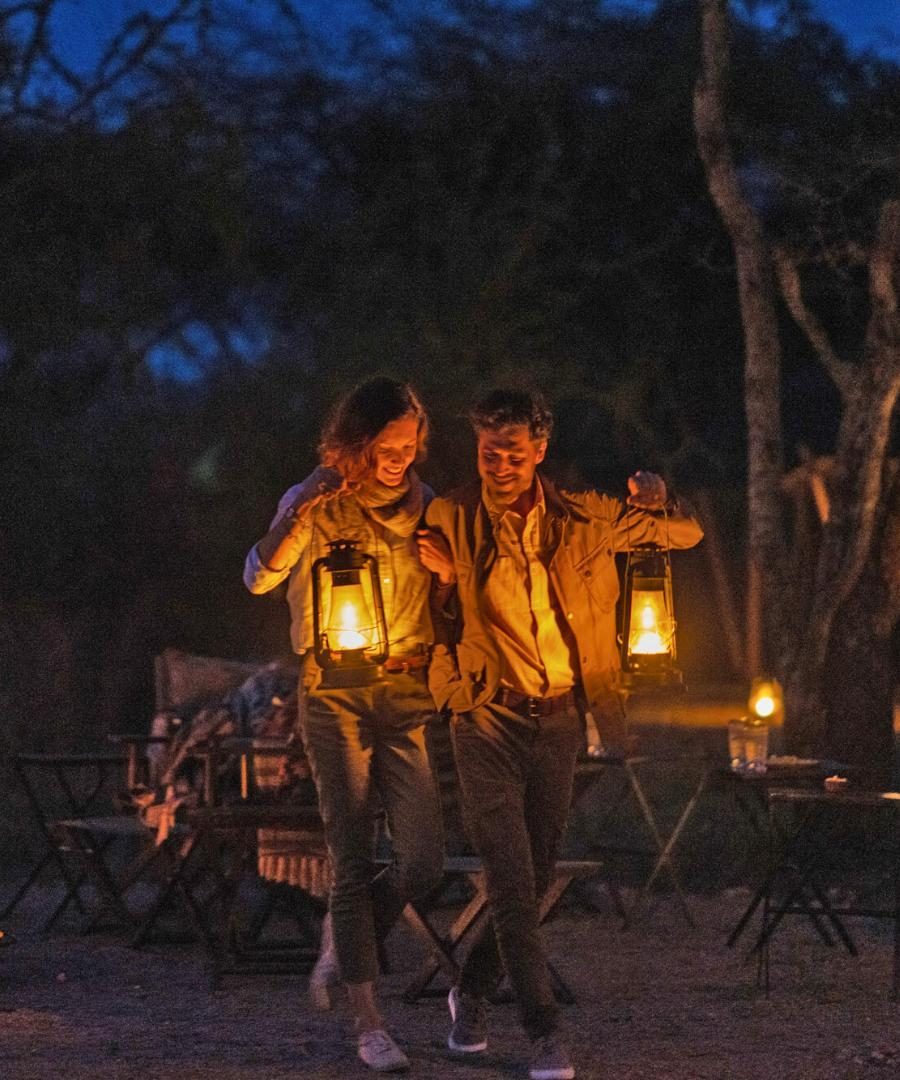 Couple Campfire at Night Songa Migrational Camp Serengeti Tanzania