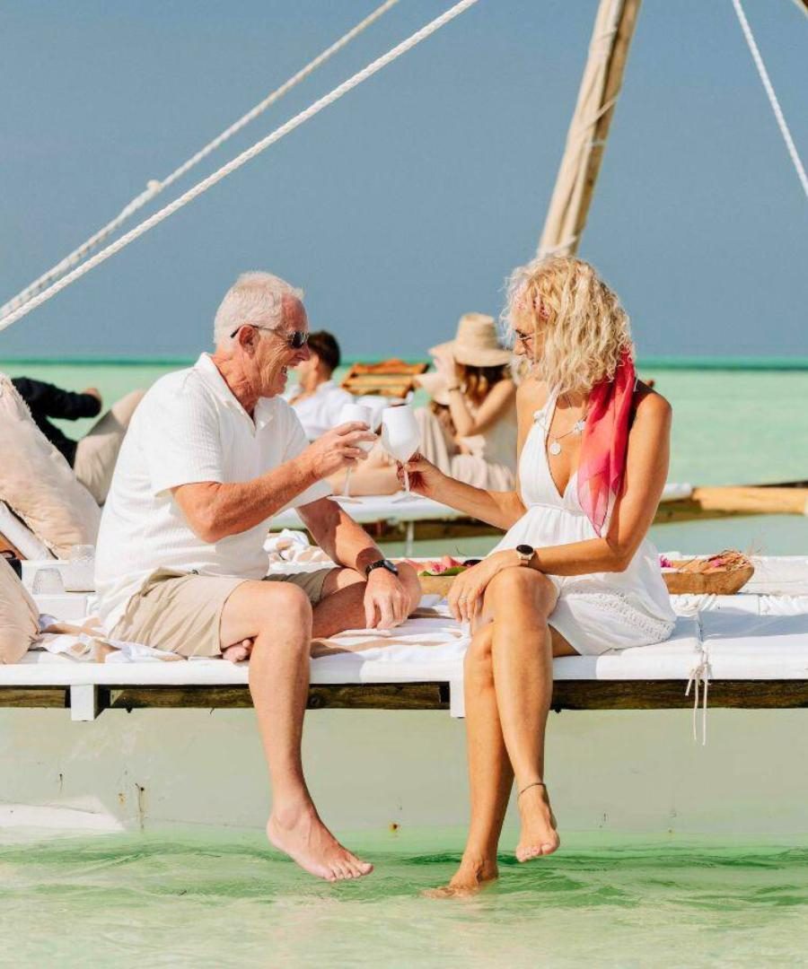 Older couple enjoying drinks on a yacht in Maldives