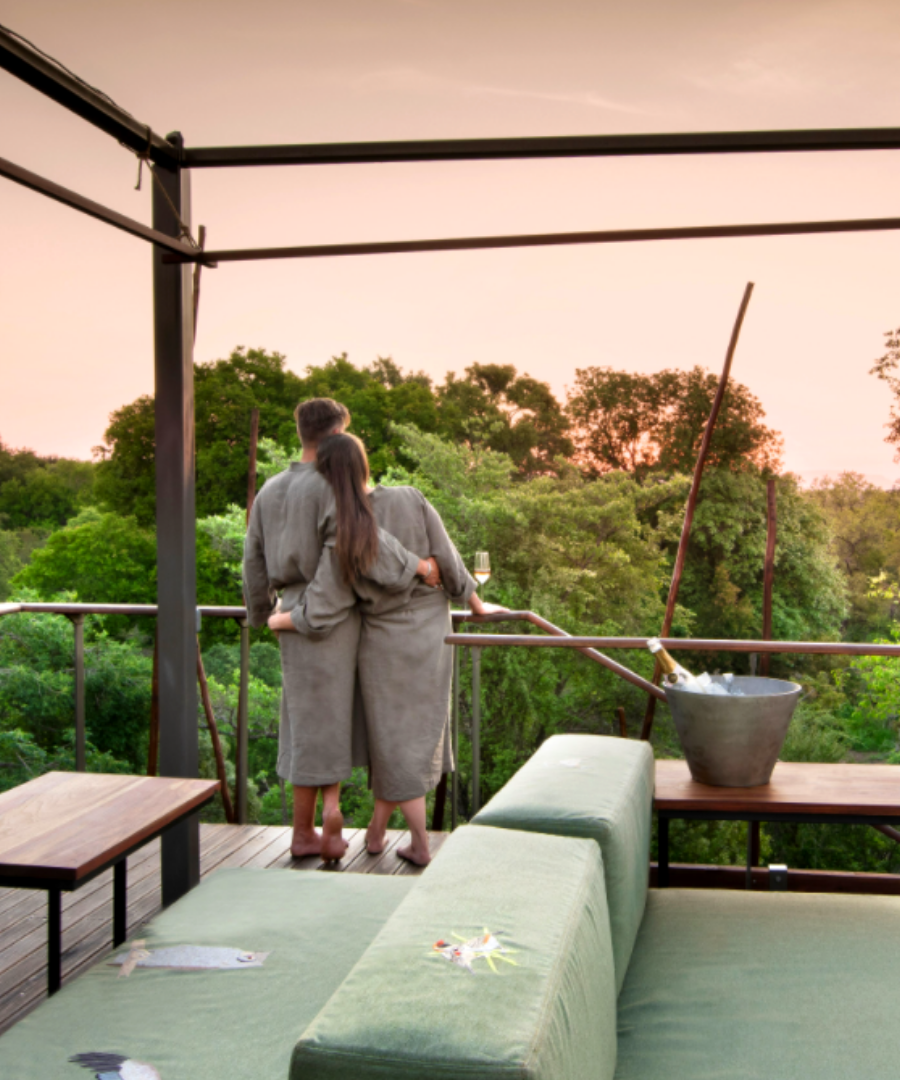 honeymoon couple looking out to the sunset