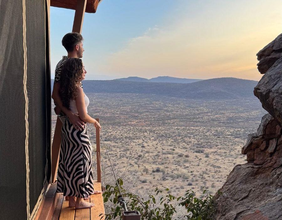 Couple look out on to Maasai Mara Plains