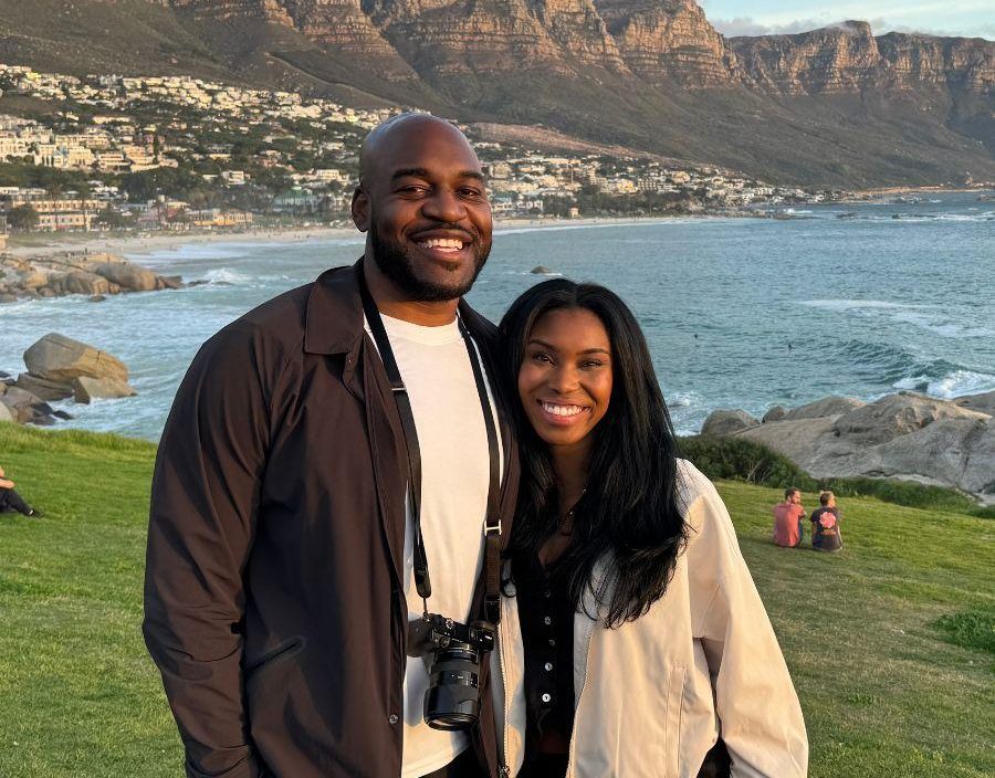 Couple pose in front of 12 apostles mountain in camps bay, south africa