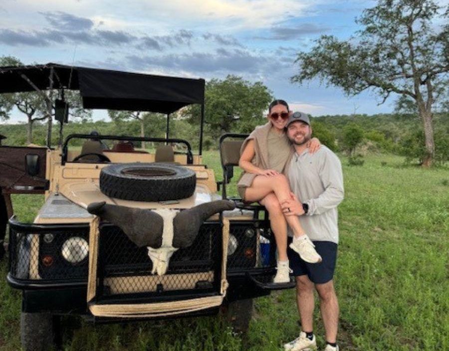 Josh Mack - couple pose of safari vehicle