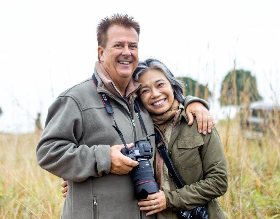 Couple pose for photo while on safari in Africa