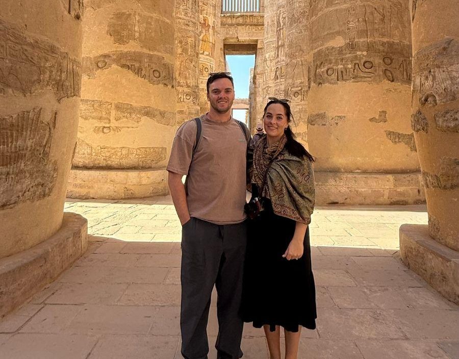 Couple pose for photo in Karnak Temple in Luxor, Egypt.