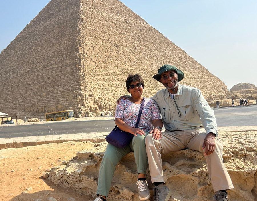 Couple pose in front of Pyramids in Egypt