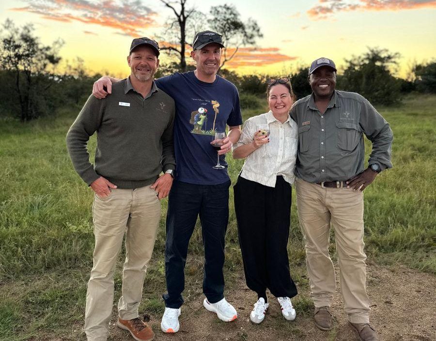 Couple stand with safari guides in South Africa