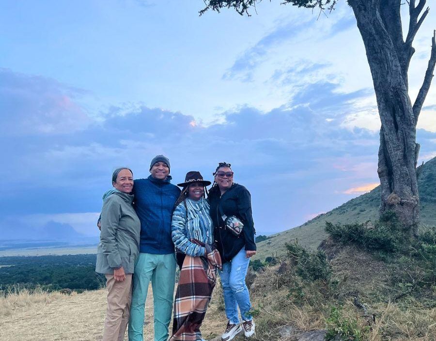 Family pose for photo of safari in East Africa