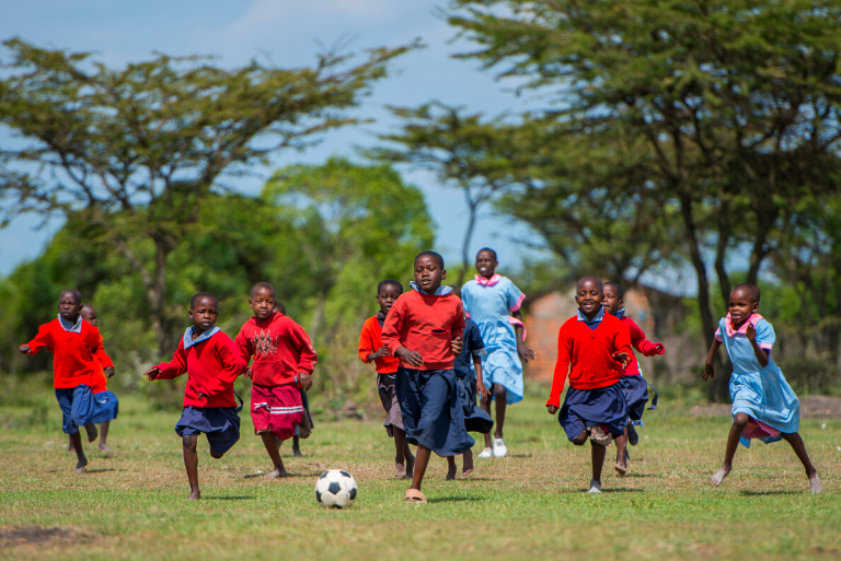 School children playing football in Africa having benefited from the Pack for a Purpose programme