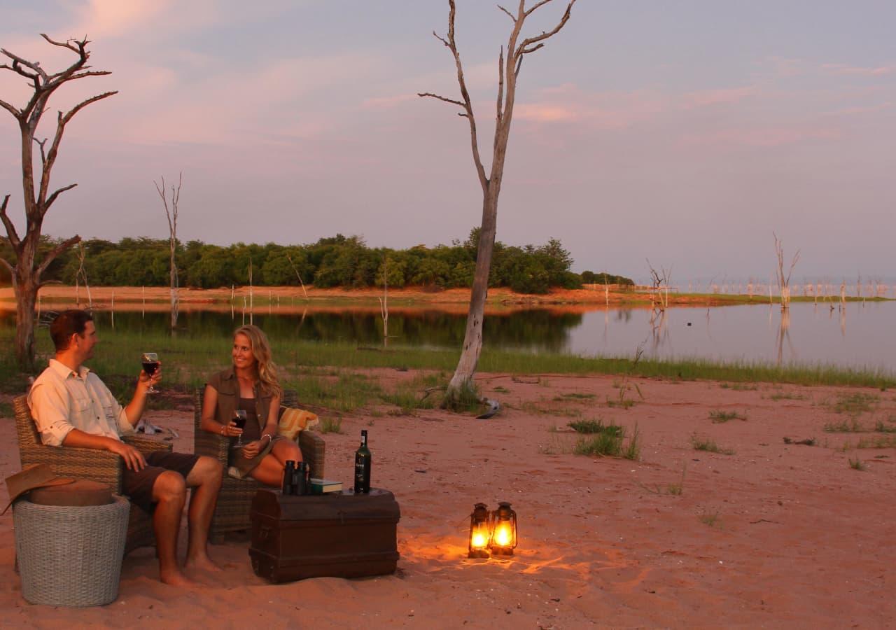 couple enjoying sunset drinks near the Zambezi River