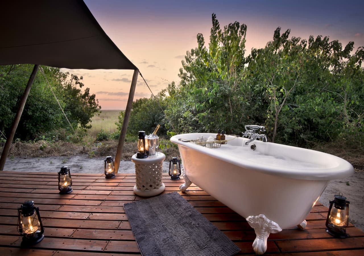 Linyanti bush camp outdoor bathtub with drinks 1280