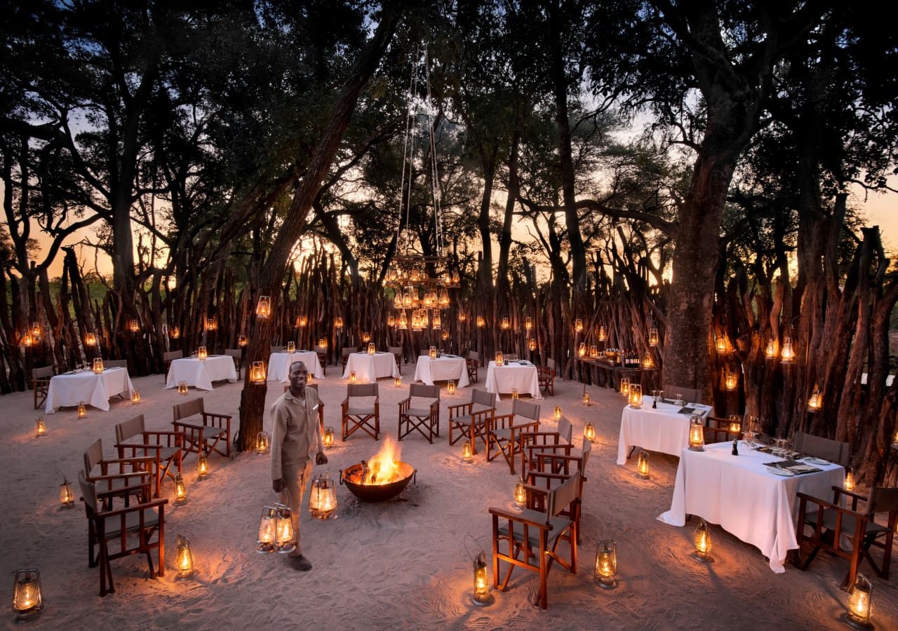 Nxabega okavango tented camp outdoor dining boma experience 1280