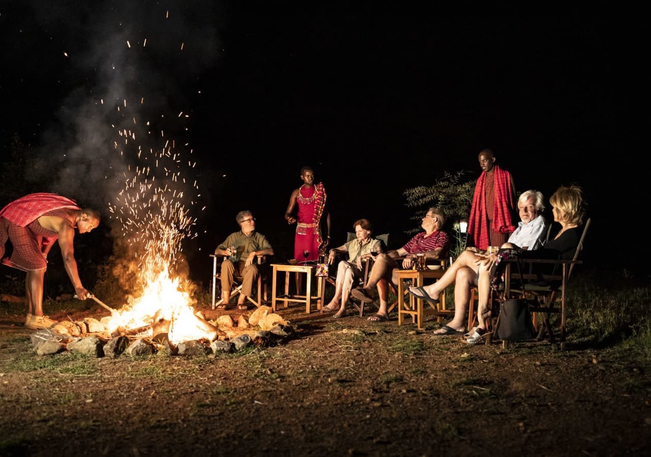 Porini lion camp campfire at night 1280