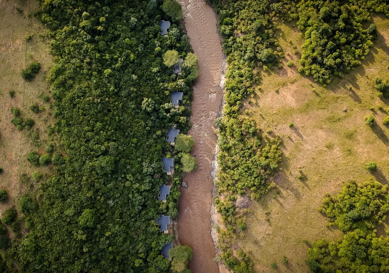 Sanctuary olonana camp aerial view of lodges by the river 1280