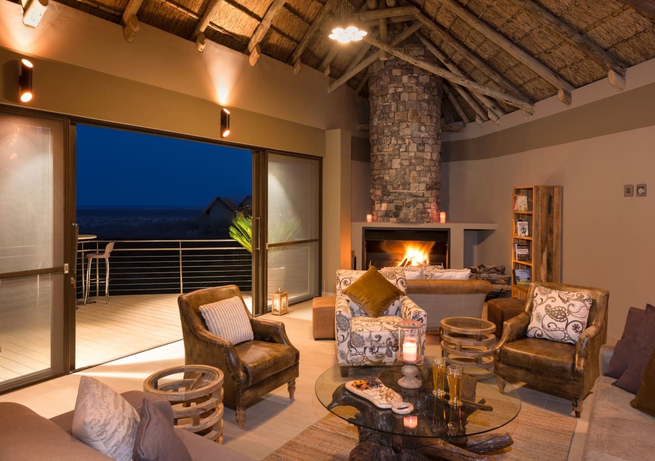 Etosha safarihoek lodge main lounge with a fireplace 1280