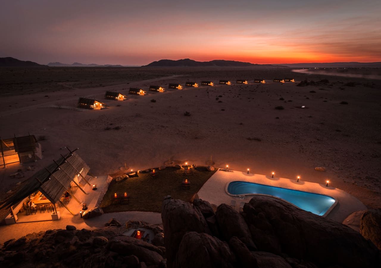 Desert quiver camp bar and pool at sunset 1280