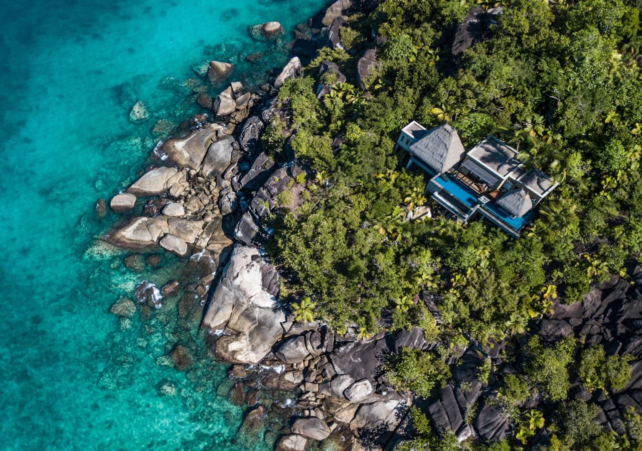 Anantara maia seychelles villas aerial view of an ocean view pool villa 1280