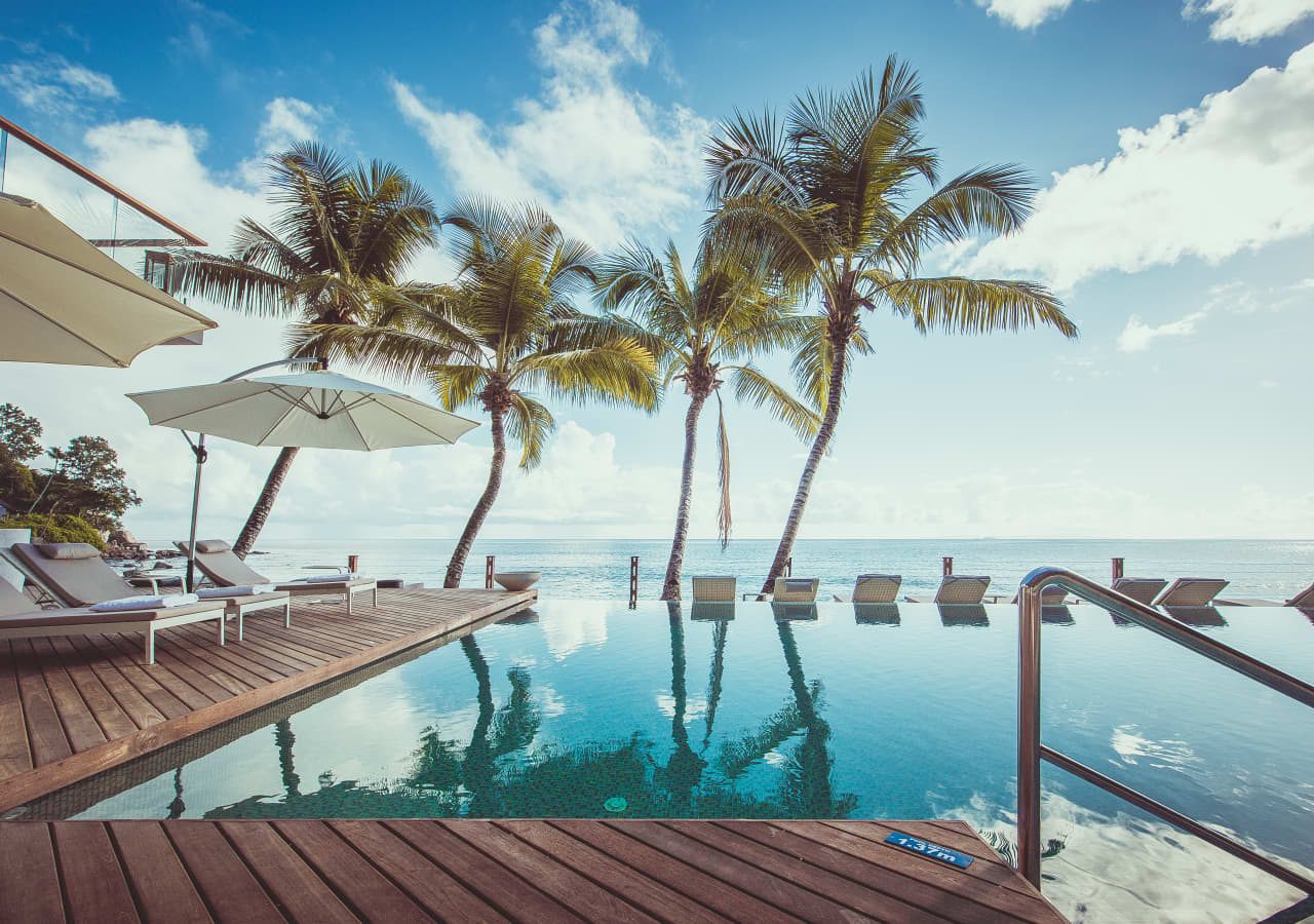 Carana beach hotel infinity pool and lounge area 1280