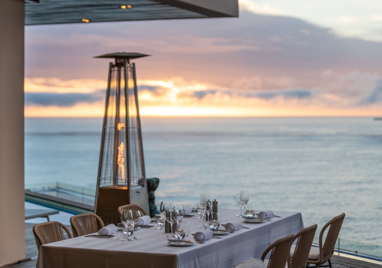 Ellerman house villas villa one outdoor dining at sunset 1280