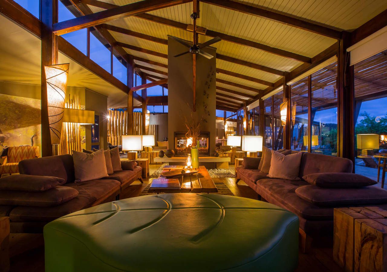 Rhino ridge safari lodge main lodge lounge with fire place 1280