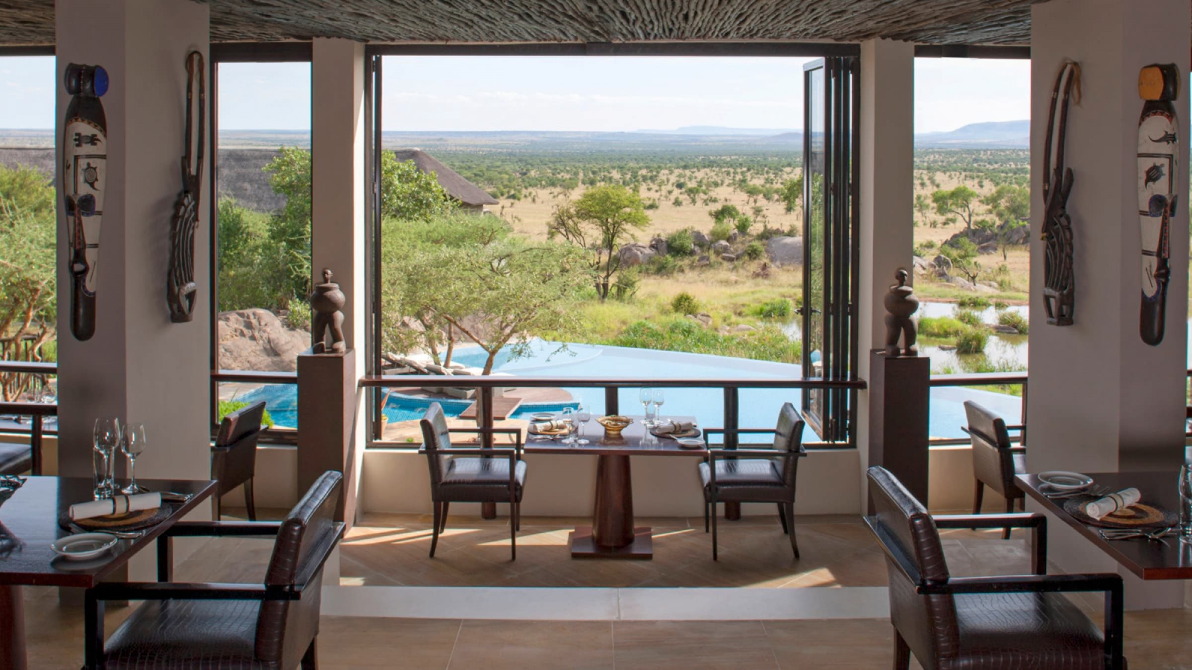 Four seasons safari lodge serengeti dining room overlooking the pool 2400