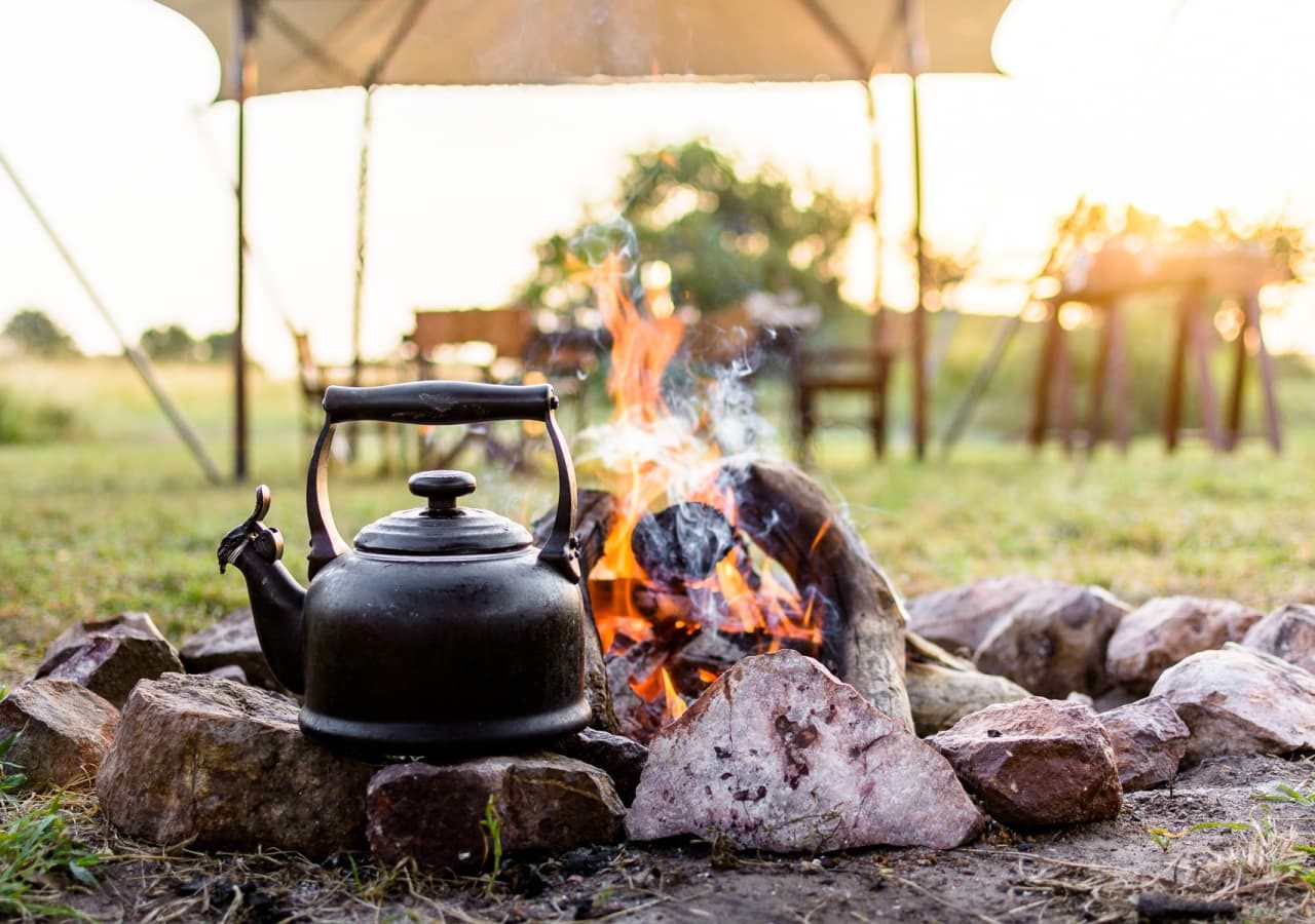 Singita explore mobile tented camp teapot heating by the firepit 1280