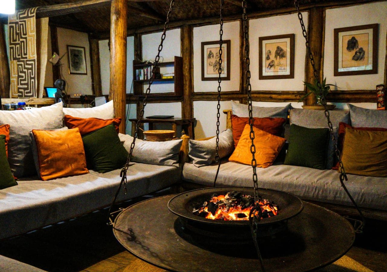 Buhoma lodge guest lounge with a fireplace 1280