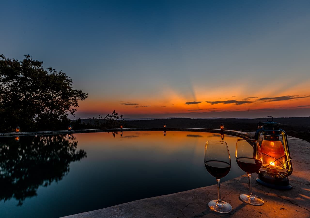 Mihingo lodge wine by the pool at sunset 1280