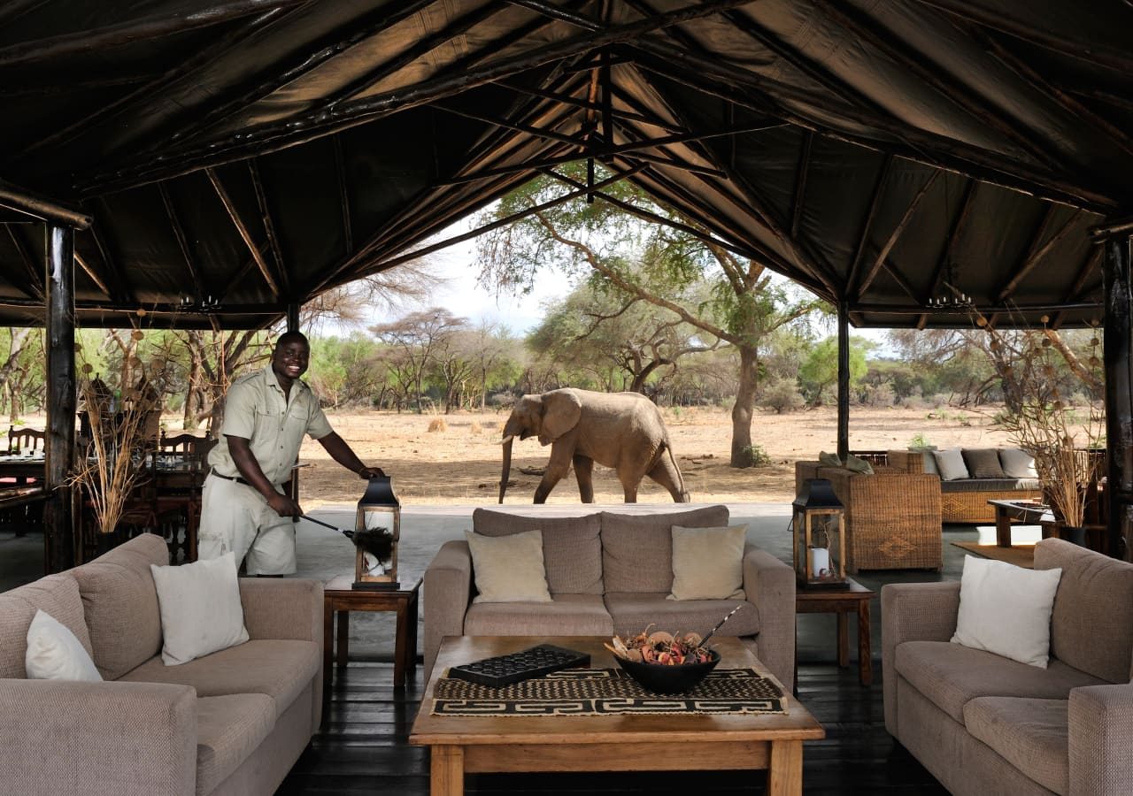 Old mondoro camp lounge area with elephant passing by 1280