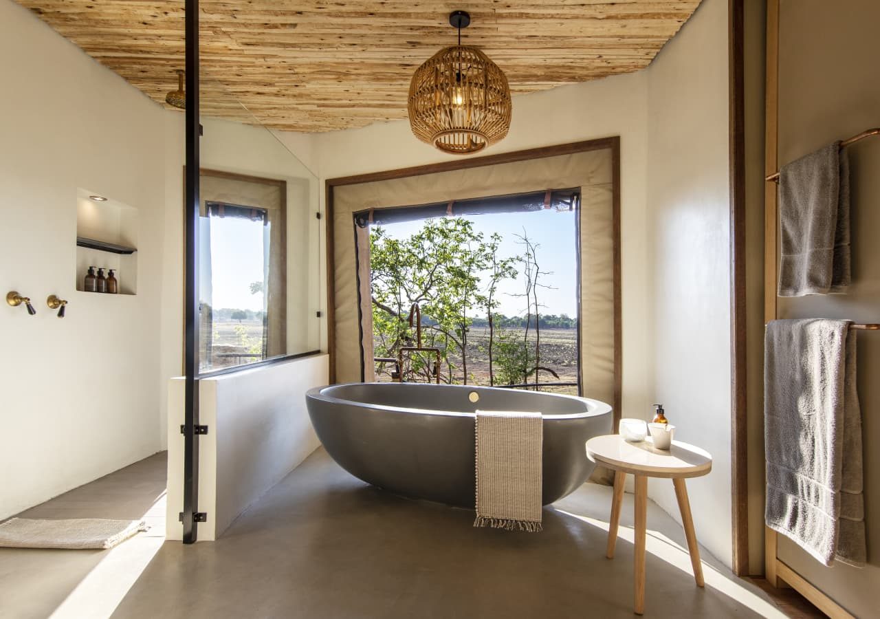 Puku ridge camp guest bathroom with a bathtub 1280