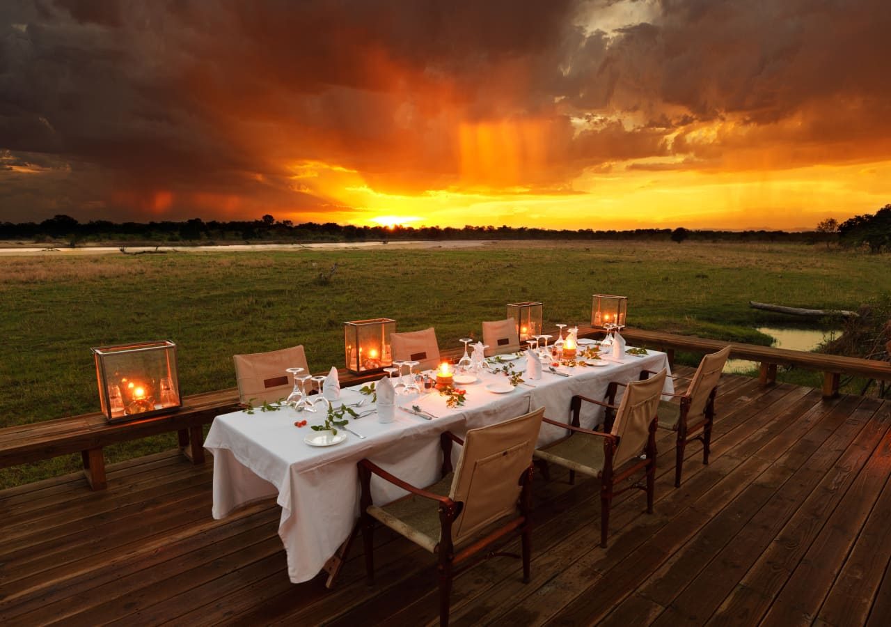 Zungulila bushcamp sunset dining on the deck 1280