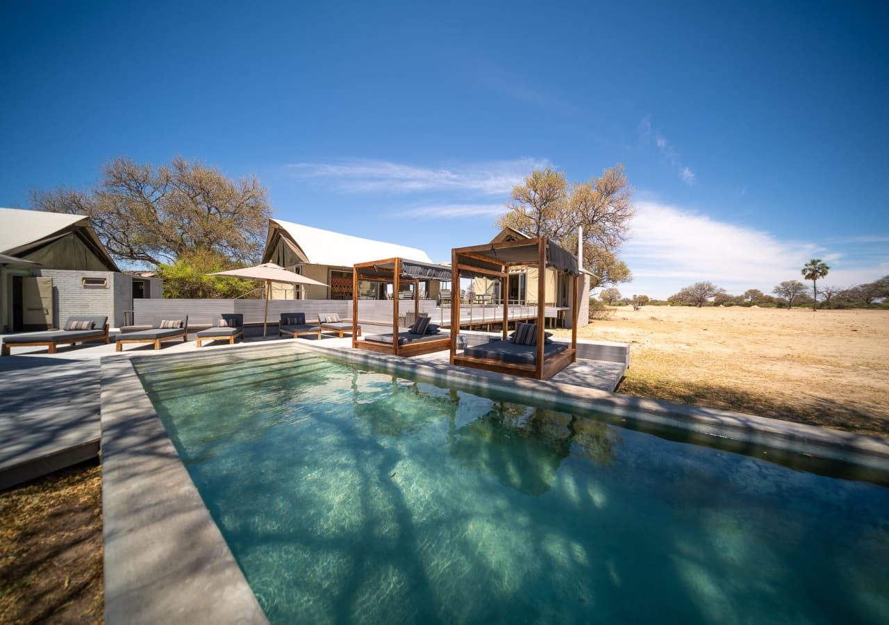 Linkwasha camp pool area with day beds 1280