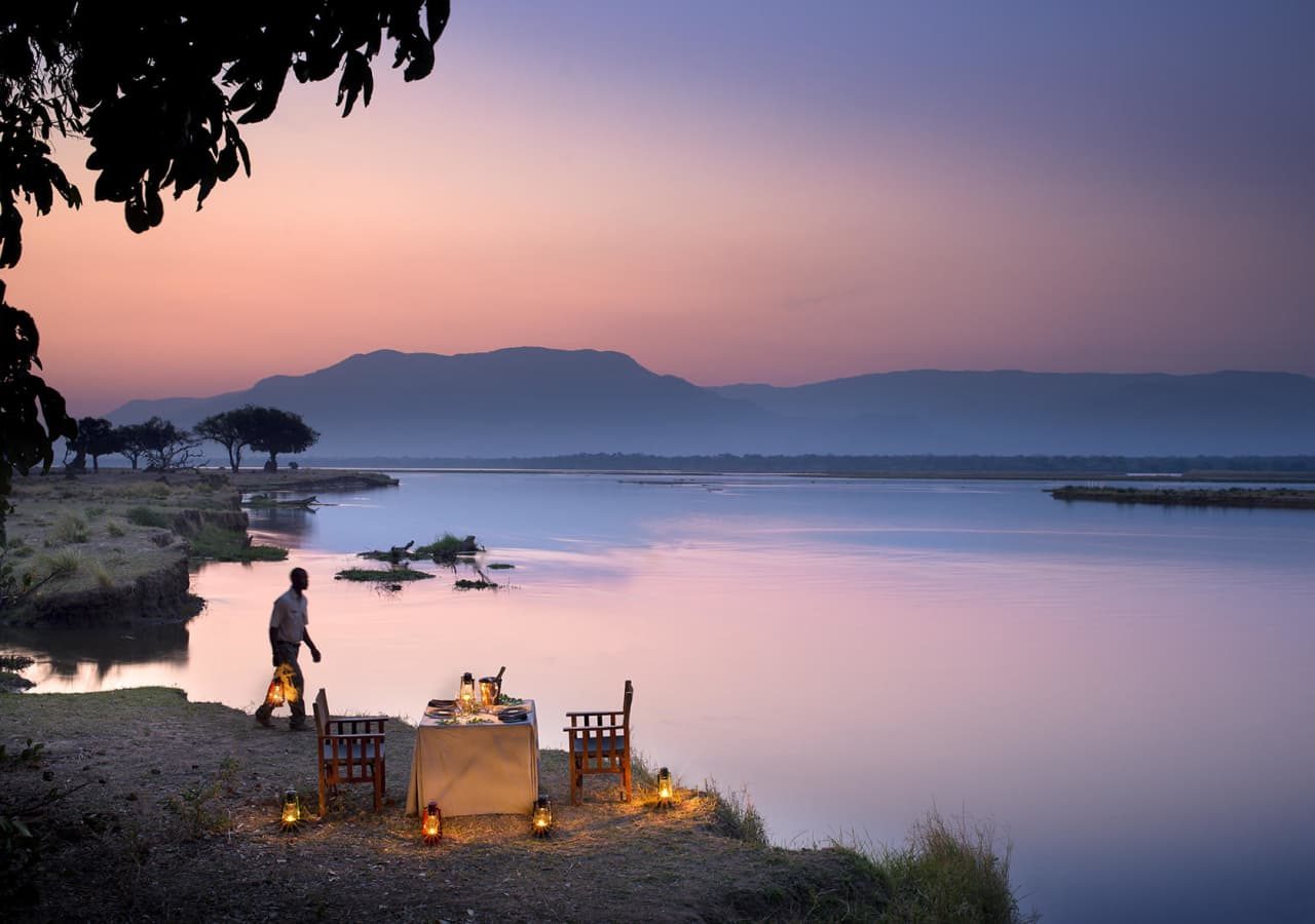 Zambezi expeditions safari camp private dinner by the water 1280