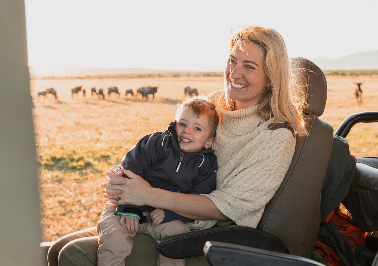 woman and young child on safari vehicle