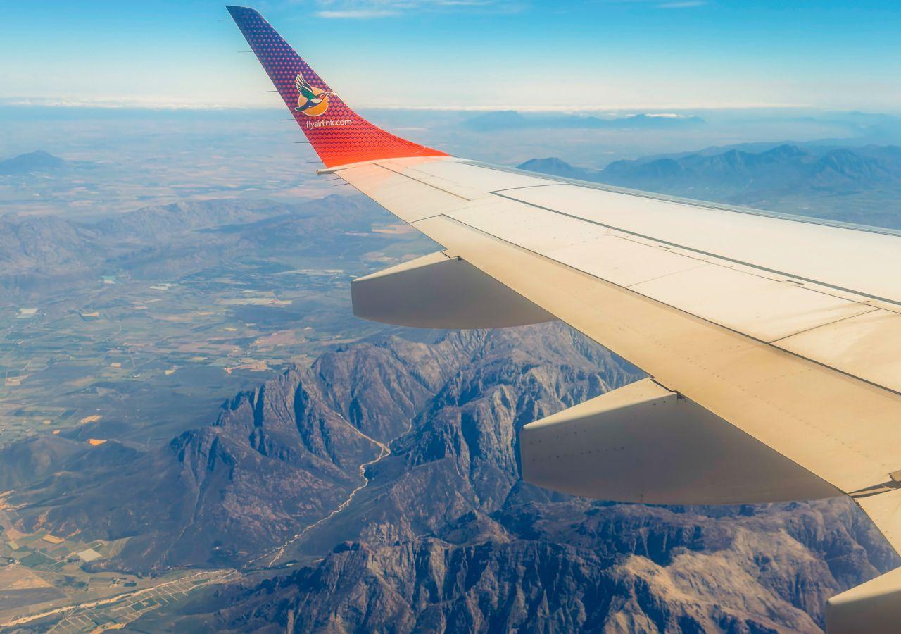 aeroplane wing while flying above mountains in South Africa