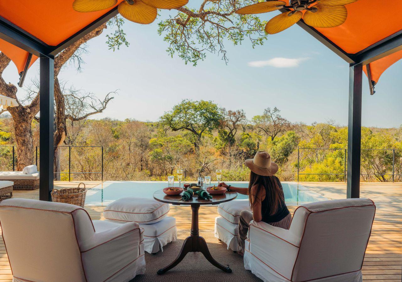 woman having lunch on a private deck at a safari lodge in South Africa